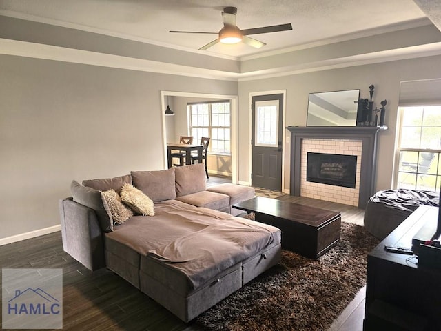 1942 Salisbury Way, Hinesville, GA 31313 - living room with a tray ceiling, crown molding, a ceiling fan, wood finished floors, and a brick fireplace