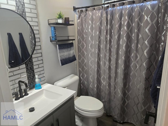 1942 Salisbury Way, Hinesville, GA 31313 - full bathroom with toilet, vanity, backsplash, wood finished floors, and a shower with curtain