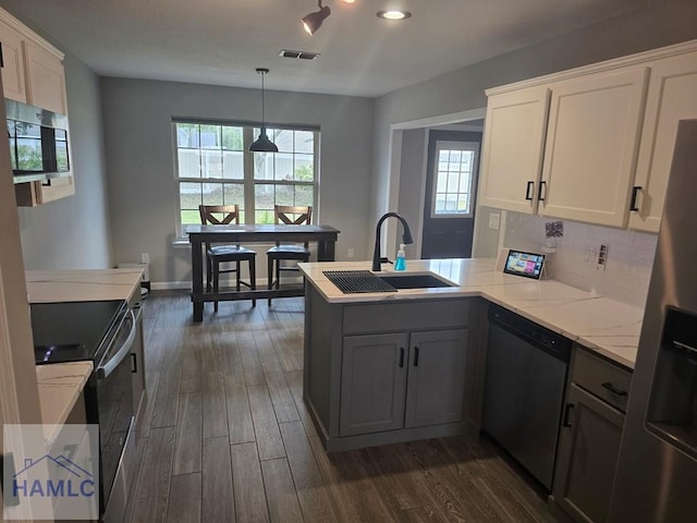 1942 Salisbury Way, Hinesville, GA 31313 - kitchen with appliances with stainless steel finishes, a sink, a peninsula, dark wood-type flooring, and white cabinets