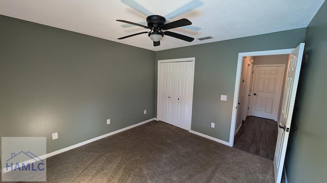 1942 Salisbury Way, Hinesville, GA 31313 - unfurnished bedroom featuring baseboards, dark colored carpet, a closet, and a ceiling fan