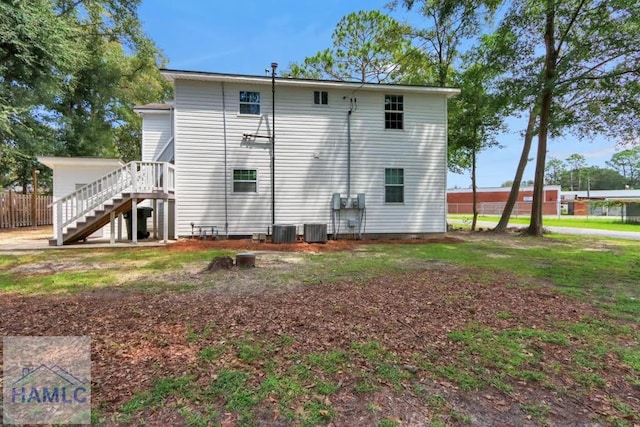 rear view of property with central AC unit