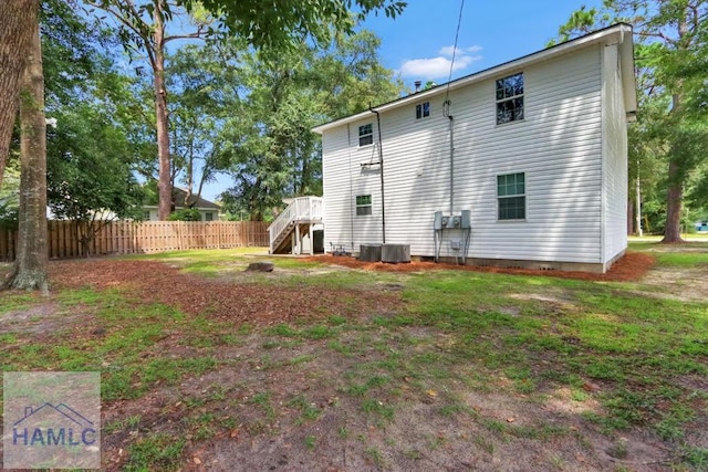 back of house with central AC unit