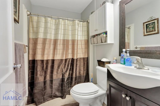 bathroom featuring tile patterned floors, vanity, and toilet