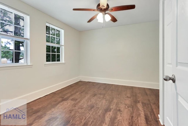 spare room featuring ceiling fan and dark wood-type flooring