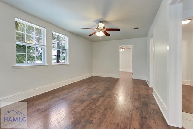 spare room featuring ceiling fan and dark hardwood / wood-style flooring