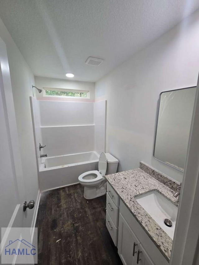 19 Cardinal Ln, Jesup, GA 31545 - full bath featuring vanity, tub / shower combination, a textured ceiling, and wood finished floors