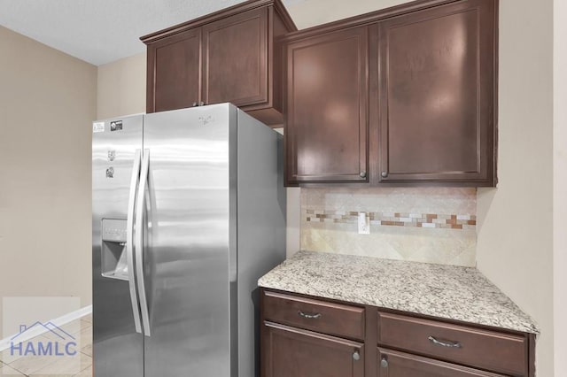 23 Veranda Trl, Midway, GA 31320 - kitchen featuring stainless steel fridge with ice dispenser, backsplash, dark brown cabinets, and light stone countertops