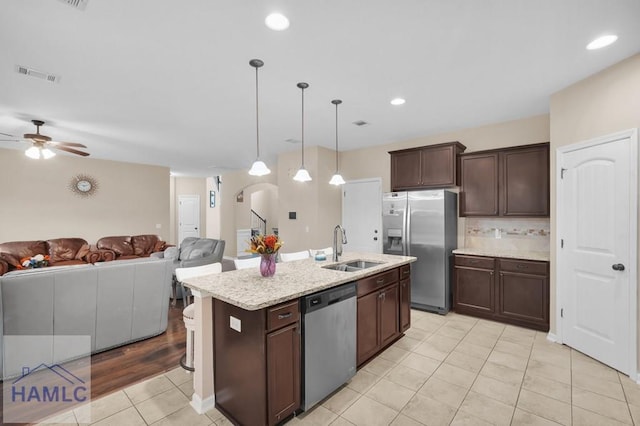 23 Veranda Trl, Midway, GA 31320 - kitchen featuring stainless steel appliances, light tile patterned flooring, a ceiling fan, open floor plan, and dark brown cabinets