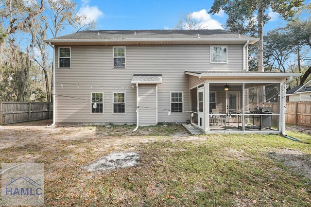 23 Veranda Trl, Midway, GA 31320 - back of property featuring a sunroom, a fenced backyard, ceiling fan, a patio area, and roof with shingles