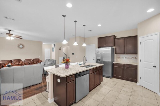 23 Veranda Trl, Midway, GA 31320 - kitchen with stainless steel appliances, light tile patterned flooring, a ceiling fan, open floor plan, and dark brown cabinets
