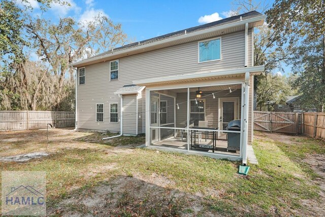 23 Veranda Trl, Midway, GA 31320 - rear view of house with a sunroom, a fenced backyard, and a gate