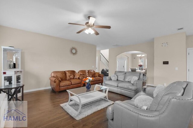 23 Veranda Trl, Midway, GA 31320 - living area with arched walkways, a ceiling fan, stairway, and dark wood-style flooring