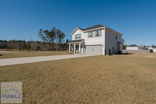 view of front of house featuring driveway, a front lawn, and an attached garage