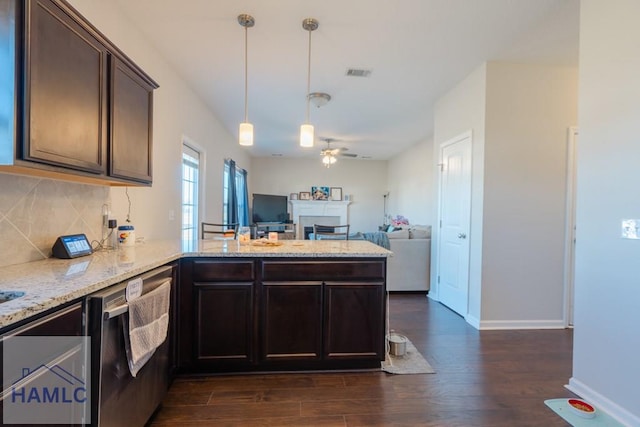 kitchen with a peninsula, dark brown cabinetry, visible vents, and dark wood-style flooring