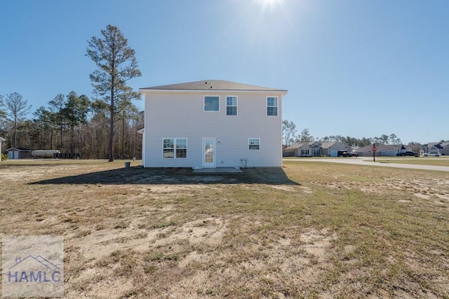 back of property featuring a patio and a yard