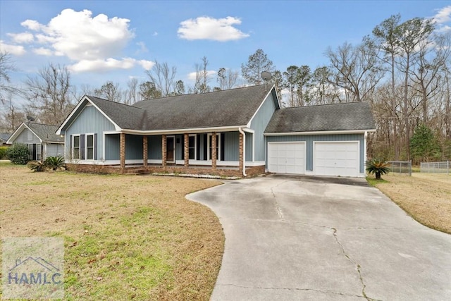 single story home featuring a porch, an attached garage, brick siding, concrete driveway, and a front yard