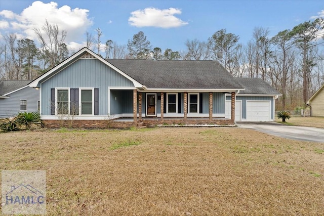 single story home featuring a front yard, concrete driveway, covered porch, and an attached garage