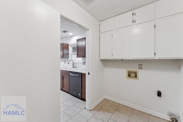 laundry room featuring hookup for a washing machine, visible vents, cabinet space, a sink, and electric dryer hookup