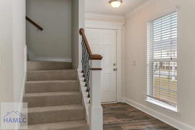 foyer entrance with dark wood-type flooring and ornamental molding