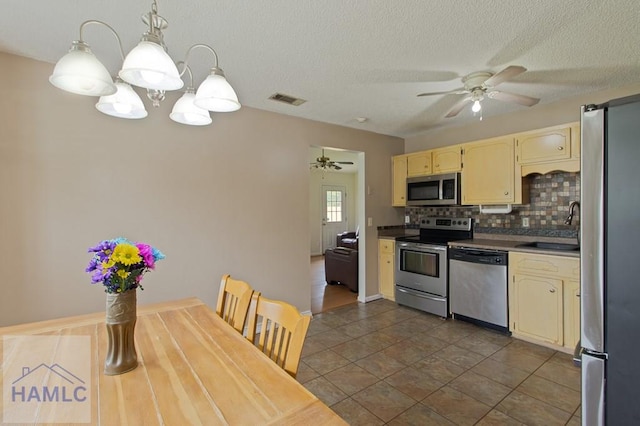 1453 Fritts Ct, Hinesville, GA 31313 - kitchen featuring stainless steel appliances, a ceiling fan, a sink, backsplash, and pendant lighting