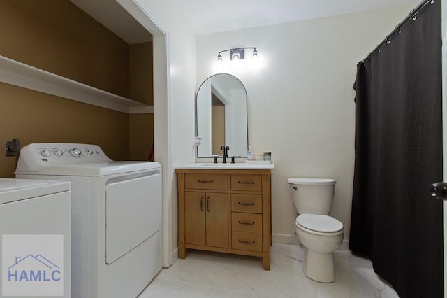 1453 Fritts Ct, Hinesville, GA 31313 - bathroom with washing machine and clothes dryer, toilet, vanity, marble look tiles, and a shower with shower curtain
