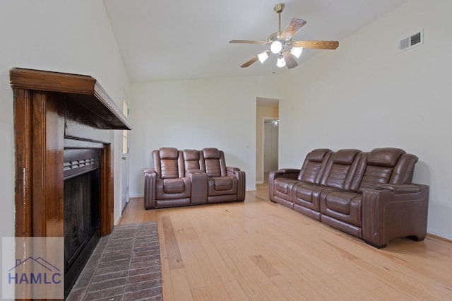 1453 Fritts Ct, Hinesville, GA 31313 - living area with vaulted ceiling, a fireplace with raised hearth, ceiling fan, wood finished floors, and baseboards