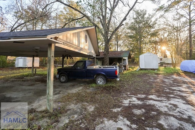 707 Church St, Claxton, GA 30417 - view of vehicle parking with a storage unit and a carport