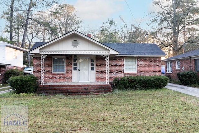 707 Church St, Claxton, GA 30417 - view of front of home with covered porch, brick siding, and a front yard