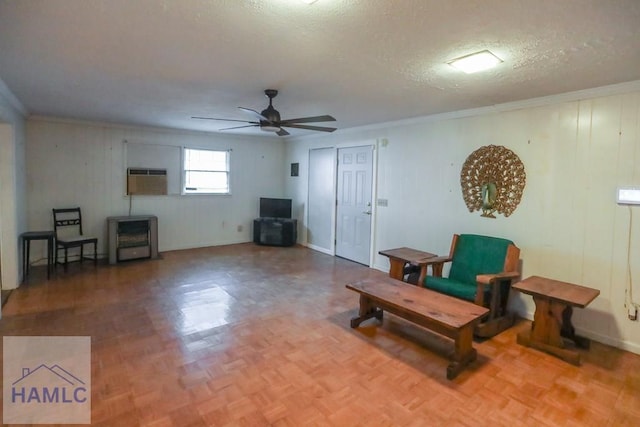 707 Church St, Claxton, GA 30417 - living area with ornamental molding, ceiling fan, a textured ceiling, and an AC wall unit