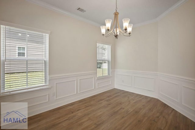 702 Fairview Cir, Hinesville, GA 31313 - unfurnished dining area with a chandelier, wainscoting, wood finished floors, and ornamental molding