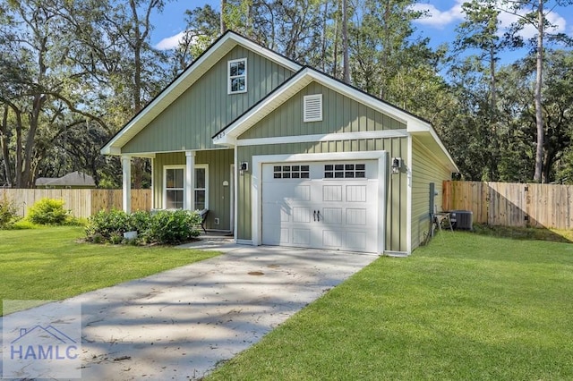 exterior space with cooling unit, a garage, and a front yard