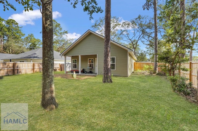 back of house featuring a lawn