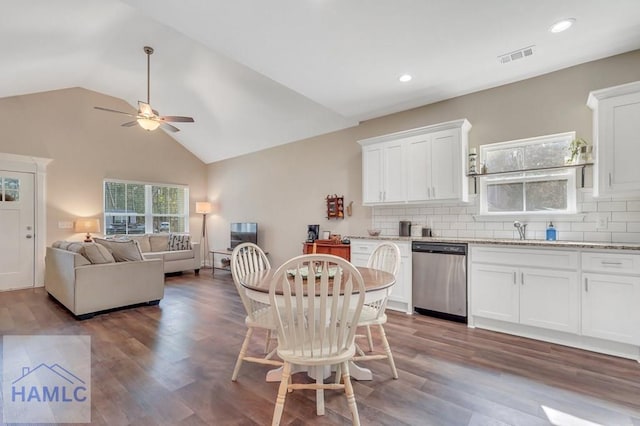 kitchen featuring stainless steel dishwasher, dark hardwood / wood-style flooring, white cabinets, and tasteful backsplash