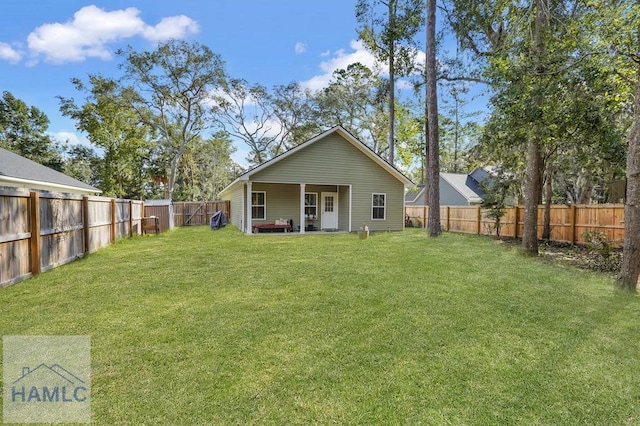 back of house featuring a yard