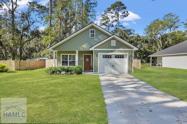 view of front of home with a front yard and a garage