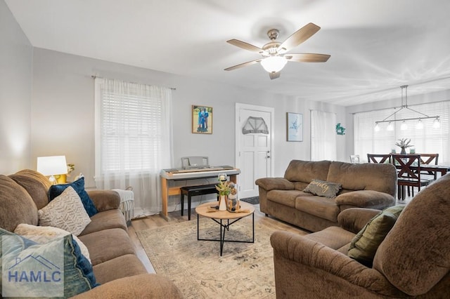 living room with ceiling fan and light hardwood / wood-style flooring