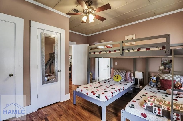 bedroom with crown molding, ceiling fan, and wood finished floors