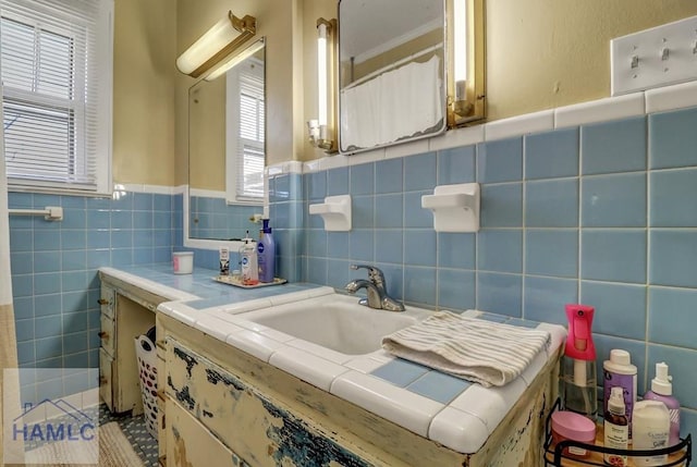 bathroom featuring vanity and tile walls