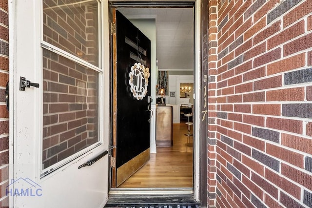 view of exterior entry with brick siding