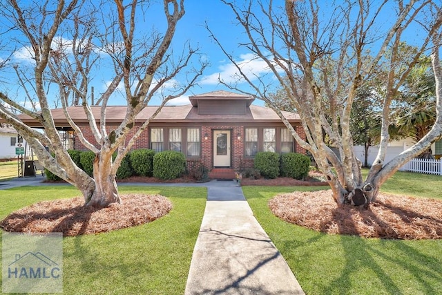 view of front of property with a front yard and brick siding