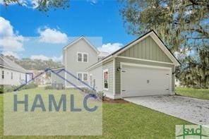 49 Salt Marsh Dr, Midway, GA 31320 - view of front of property with board and batten siding, driveway, a garage, and a front lawn