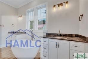 49 Salt Marsh Dr, Midway, GA 31320 - bathroom featuring a soaking tub and vanity