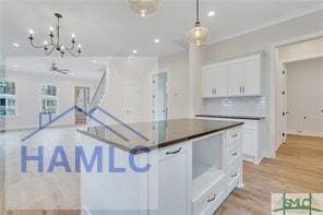 49 Salt Marsh Dr, Midway, GA 31320 - kitchen with white cabinetry, recessed lighting, a chandelier, light wood-style floors, and pendant lighting