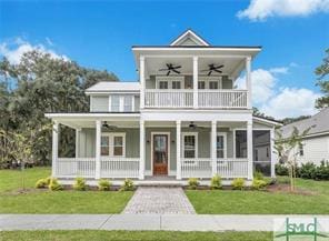 49 Salt Marsh Dr, Midway, GA 31320 - view of front of property with ceiling fan, covered porch, a balcony, and a front lawn