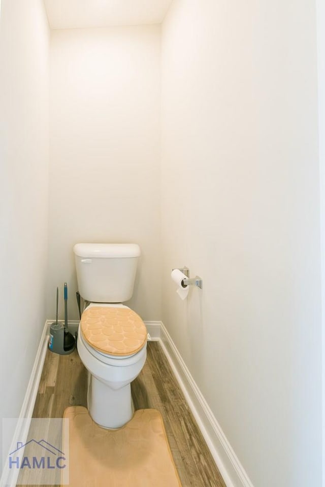 bathroom featuring hardwood / wood-style flooring and toilet