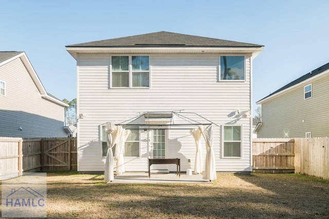 back of house featuring a yard and a patio