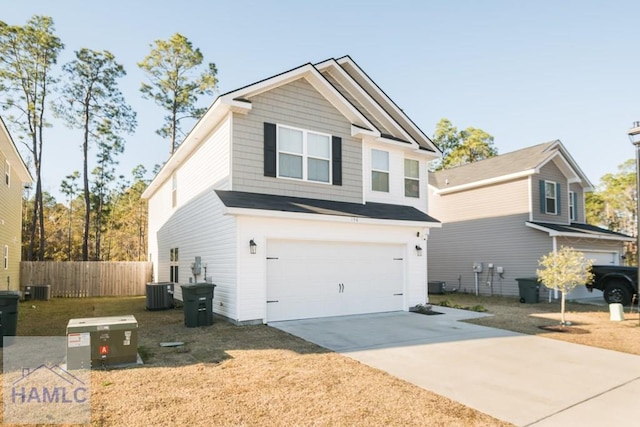 view of front facade featuring cooling unit and a garage