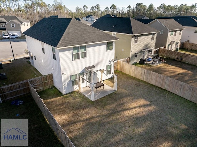 back of property featuring a lawn, central air condition unit, and a patio