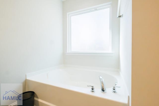 bathroom with a tub to relax in