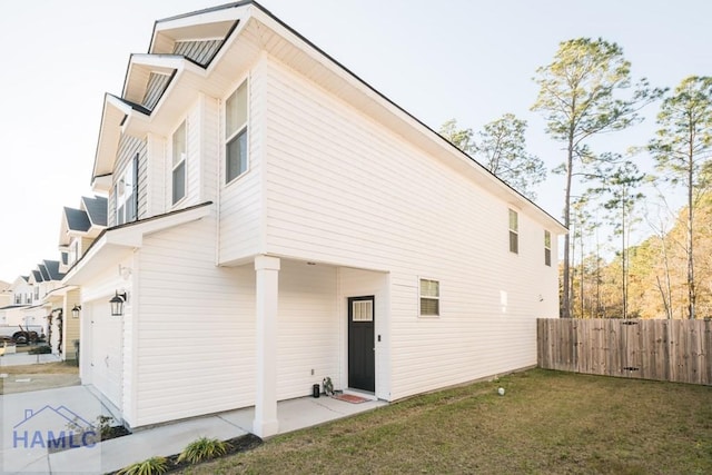 rear view of property featuring a yard and a garage